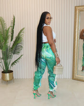 Load image into Gallery viewer, Bring all the drama to your weekend with these Ms. Miami swirl pants. Featuring a relaxing fit designed to cinch the waist while loosely hang on the legs for an hourglass silhouette, and unique twill tassel side detailing, how can you not be obsessed? Style these swirl pants with a statement top, heels and designer sunglasses for a look that will really make you stand out from the crowd.