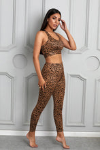 Load image into Gallery viewer, Stand out from the crowd with a sexy pop of print to inspire your new moves. Work out in style with this eye-catching leopard print workout set that comes with a racerback sports bra and high-rise leggings. This style looks great back with the matching tight and a cut out back top to show off the back strap detail. Moisture wicking and breathable, you'll feel cool, comfortable and stylish. This set is perfect if you want to look stylish while working out in gym or studio.