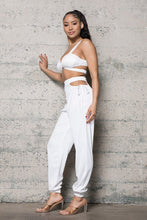 Load image into Gallery viewer, Add some sexy satin feels into your weekend look with this dreamy satin set. This Always In My Prime Two-Piece Satin set featuring soft material with a cross back satin bustier bra the back has an elastic waist band. The pants have a sexy side waist opening and adjustable straps on and elastic or the legs, we're obsessed. Style with the cute clutch, high heels and statement accessories for a look like no other.