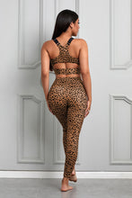 Load image into Gallery viewer, Stand out from the crowd with a sexy pop of print to inspire your new moves. Work out in style with this eye-catching leopard print workout set that comes with a racerback sports bra and high-rise leggings. This style looks great back with the matching tight and a cut out back top to show off the back strap detail. Moisture wicking and breathable, you'll feel cool, comfortable and stylish. This set is perfect if you want to look stylish while working out in gym or studio.