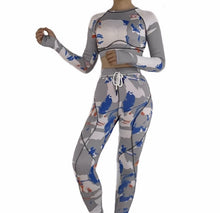 Load image into Gallery viewer, Our gray bad ting two piece yoga set is made with colorful seamless fabrics that are soft and stretch effortlessly with your movements, easy to pull-on and very comfortable to wear. Yoga set comes with a long sleeve crop top with thumb holes, leggings with a elastic waist band drawstring detail. Pair this cute yoga set with some sneakers and yoga mat.