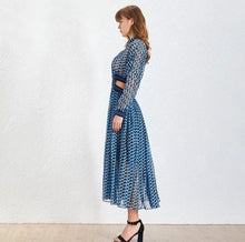 Load image into Gallery viewer, This dress is everything babe! From the vibrant color blue wave pattern. We're literally obsessed with this dress! This gorgeous sheer statement dress has a mini lining underneath. Featuring a round crewneck line, back button closure, sheer material, cut out side design. You can pair it with a red or transparent high heels and mini bag for a standout look that'll have all eyes on you!