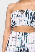 Load image into Gallery viewer, Keep it totally trendy in tie dye and get in touch with your playful side! This multi color crop top features a strapless neckline and a elastic band hem. The vibrant blues, pink, and lilac and compose a fun tie dye pattern. Pair this set with a simple high heels, silver accessories and mini bag for a complete look.