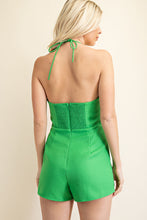 Load image into Gallery viewer, Be sure to stand out in sweeter than ever kelly green romper wherever you go from day to night in style! Featuring shapes, a strapless neckline, halter necktie, elastic at the back and a cut out front, textured woven fabric and princess bow. Totally on-trend, tie-front detail accents this chic romper perfectly while pleated shorts complete the look! Hidden back zipper/clasp.