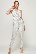 Load image into Gallery viewer, We're loving this jumpsuit the perfect 'gram-worthy fit. Whether you're looking to create a casual look or dress it up for a more work-friendly look, this piece has got you covered! This jumpsuit features soft satin material, halter, pockets, and elastic waistband drawstring. Pair this piece with a transparent high heel, gold accessories, and a handbag for an outfit you will love!