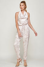 Load image into Gallery viewer, We're loving this jumpsuit the perfect 'gram-worthy fit. Whether you're looking to create a casual look or dress it up for a more work-friendly look, this piece has got you covered! This jumpsuit features soft satin material, halter, pockets, and elastic waistband drawstring. Pair this piece with a transparent high heel, gold accessories, and a handbag for an outfit you will love!
