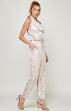 Load image into Gallery viewer, We're loving this jumpsuit the perfect 'gram-worthy fit. Whether you're looking to create a casual look or dress it up for a more work-friendly look, this piece has got you covered! This jumpsuit features soft satin material, halter, pockets, and elastic waistband drawstring. Pair this piece with a transparent high heel, gold accessories, and a handbag for an outfit you will love!