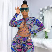 Load image into Gallery viewer, Colorful Jungle Jumpsuit - Multi Color Get ready to flaunt your flawless summer body in this colorful sexy jumpsuit! The lace up detail and front cut out will give you a flattering silhouette and ultra sexy look. Wear this snake skin jumpsuit with your favorite heels, golden hoops and handbag for an edgy glam look.