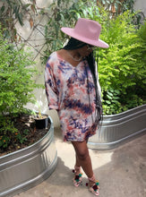 Load image into Gallery viewer, Dipped N' Sunset - Peach Pryceless Angels we're obsessing over this tie dye high low mini print dress! You can wear it from work to a night out, this dress is super versatile for multiple occasions! This loose fitting dress has a soft satin feel featuring two side pockets a multicolored tie dye print, V- Neck, you definitely need this in your new season collection. Pair with a strappy peach, pink or transparent high heels and clutch for a complete look.