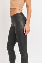 Load image into Gallery viewer, Every fashionista knows she must have a pair of faux snake skin leather leggings in her fall fashion wardrobe. Featuring a high fashion faux leather fabric and body sculpting fit. Make these pants this seasons go-to when dressing them up with your favorite pieces from home!
