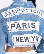 Load image into Gallery viewer, Update your denim collection with our cropped jacket we are obsessing over. Featuring a mid wash denim material with a raw edge and a cropped length, double up your denim with our matching mid-wash jeans and a nude crop top for a combo that can be dressed up or down.