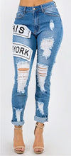 Load image into Gallery viewer, We are obsessing over these distressed mid rise jeans. Featuring a trendy medium wash denim, distressed and, patchwork features. Make these jeans your go-to to when putting together the perfect outfit. Pair these jeans with a statement top and our favorite transparent heels for a look we're loving.