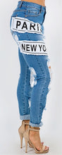 Load image into Gallery viewer, We are obsessing over these distressed mid rise jeans. Featuring a trendy medium wash denim, distressed and, patchwork features. Make these jeans your go-to to when putting together the perfect outfit. Pair these jeans with a statement top and our favorite transparent heels for a look we're loving.