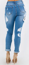 Load image into Gallery viewer, We are obsessing over these distressed mid rise jeans. Featuring a trendy medium wash denim, distressed and, patchwork features. Make these jeans your go-to to when putting together the perfect outfit. Pair these jeans with a statement top and our favorite transparent heels for a look we're loving.