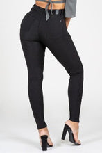 Load image into Gallery viewer, If you don't have this closet essential, you are missing out! These high rise, black, skinny jeans are made of super stretchy material and making them the jeans that every girl needs. They feature two back pockets and a front zipper and button to close. These are the pants that you can wear to work, dinner, or the club. Pair with heels and a great top to create the perfect outfit.
