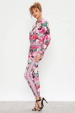 Load image into Gallery viewer, We're bringing you the ultimate Flowers and Camo tracksuit! Perfect for building your favorite looks all year round. This tracksuit is luxurious, has excellent stretch, and extremely comfortable. The jacket is long sleeve, soft stretch fit, with a front zipper. The bottoms are stretchy waistband and hugs you in all the right places. Pair with transparent heels, gold jewelry to create a cute and casual look.