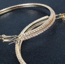 Load image into Gallery viewer, Add some sparkle and shine with these beautifully detailed gold hoop earrings. Featuring jeweled detailing on a gold-tone setting, these earrings are perfect for all occasions.