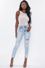 Load image into Gallery viewer, If you don't have this closet essential, you are missing out! These high rise, distressed denim medium wash, skinny jeans are a must have! They feature two back, two front pockets and a front zipper and button to close, distressed details to have you styling at the top of your game. We love pairing our denim distressed jeans with heels for a classier look or with some booties to bring some edge!