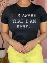Load image into Gallery viewer, This is a must in your wardrobe! Our I'm Aware That I'm Rare Top has plenty of confidence and is a statement piece. Has a crew neck, short sleeves, loose fitting and soft fabric. Style it with your favorite jeans and high heels for an elevated casual look.