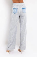 Load image into Gallery viewer, In The Mix Denim Sweatpants. These bottoms are made from a mix of heather grey cotton sweat and light wash denim fabrication. These pants feature distressed rips at the knees, straight leg pants, an elastic waistband, two front and back pockets, and a button detail. Style these with a cropped hoodie and a pair of white sneakers!