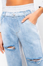 Load image into Gallery viewer, In The Mix Denim Sweatpants. These bottoms are made from a mix of heather grey cotton sweat and light wash denim fabrication. These pants feature distressed rips at the knees, straight leg pants, an elastic waistband, two front and back pockets, and a button detail. Style these with a cropped hoodie and a pair of white sneakers!