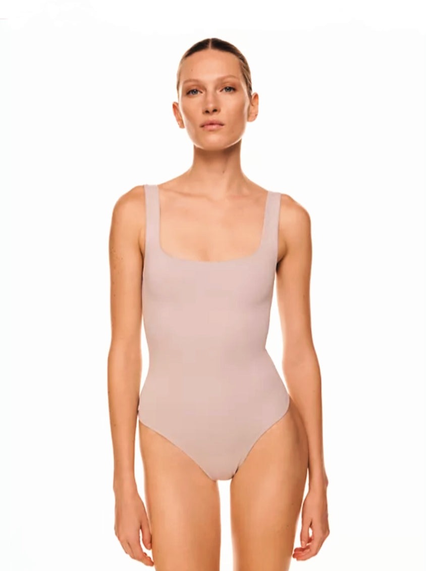 The Essential Bodysuit you never knew you needed is right here! Featuring a very smooth and stretchy material, scoop neckline and a swimsuit like build with a snap closure. Pair this Mauve bodysuit with any of our favorite Hybrid Dream Jeans, shorts, leggings and more for the look you'll love.   