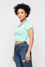 Load image into Gallery viewer, Crop tops are essential in every girls wardrobe and we're obsessing over our vibrant mint crop top. Featuring a stretch kitted material with short sleeves and a round neckline, and a cut-out detailing which exposes the skin for a real statement-making look. Pair with your favorite blue wash denim jeans or with cargos and high heels to complete the look