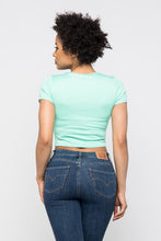 Load image into Gallery viewer, Crop tops are essential in every girls wardrobe and we're obsessing over our vibrant mint crop top. Featuring a stretch kitted material with short sleeves and a round neckline, and a cut-out detailing which exposes the skin for a real statement-making look. Pair with your favorite blue wash denim jeans or with cargos and high heels to complete the look
