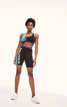 Load image into Gallery viewer, Nautica Viola Bra Top - Black This statement bra top is the perfect addition to your Spring, Summer wardrobe. With bright block colors and contrasting branding you can be sure to chill in style. 
