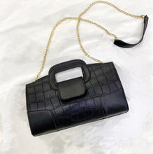 Load image into Gallery viewer, Finish off your evening look with this classy handbag babe. Featuring a black faux leather material, and this bag comes with a crossbody strap, a gold link strap for the shoulder, front flap design and a metal popper fastening. Style with any of your night time looks!