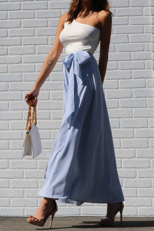 This one shoulder white & blue striped maxi dress with slit is so beautiful! We love the striped design, one shoulder style and a side slit. Great for any upcoming semi formal events or even just simply to run errands. Picture yourself on vacation with this beautiful maxi, you'll definitely turn heads! Pair with a simple high heel, gold accessories and handbag for a complete look.
