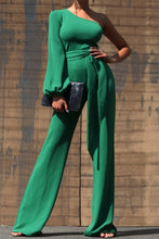 Load image into Gallery viewer, One Shoulder Jumpsuit - Dark Green This jumpsuit is a statement in itself! Perfect for all of your summer fun! This green jumpsuit comes in a wide pant leg featuring a long sleeve one shoulder, adjustable tie belt, and side zipper. Pair this with a stylish heel and handbag for a complete look.