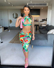 Load image into Gallery viewer, This sexy Picasso skirt set is everything and a definite must have for your wardrobe babe. Easy to style and has plenty stretch! This super cute skirt set comes in a mid length featuring a ruched detail, elastic waistband and matching cross wrap top. Pair with a statement high heels and handbag for a complete look.