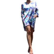 Load image into Gallery viewer, Dipped N' Sunset - Blue Pryceless Angels we're obsessing over this tie dye high low mini print dress! You can wear it from work to a night out, this dress is super versatile for multiple occasions! This loose fitting dress has a soft satin feel featuring two side pockets a multicolored tie dye print, V- Neck, you definitely need this in your new season collection. Pair with a strappy blue, pink or transparent high heels and clutch for a complete look.