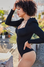 Load image into Gallery viewer, You're sure to turn a head and drop a jaw with this puff-sleeved bodysuit. It's perfect for adding to any outfit of the day. Featuring a black stretchy ribbed material with puff long-sleeves, Sweetheart neckline, padded cups, and attached thong bottoms with snap closures. Team it with some light wash jeans, cute high heels, layered jewelry, and a clutch purse for a fun and flirty look.