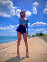 Load image into Gallery viewer, We're bringing the heat with these flowy swing it baby shorts! Great for day parties with your girls or even a night out with your bae! These shorts come in a soft black material, front zip and button closure. Style these sexy shorts with a white bodysuit or a rhinestone denim corset, simple high heels and handbag for a complete look!