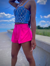 Load image into Gallery viewer, We're bringing the heat with these flowy swing it baby shorts! Great for day parties with your girls or even a night out with your bae! These shorts come in a soft hot pink material, front zip and button closure. Style these sexy shorts with a white bodysuit or a rhinestone denim corset, simple high heels and handbag for a complete look!