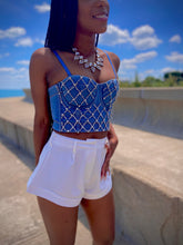 Load image into Gallery viewer, We're bringing the heat with these flowy swing it baby shorts! Great for day parties with your girls or even a night out with your bae! These shorts come in a soft white material, front zip and button closure. Style these sexy shorts with a rhinestone denim corset, simple high heels and handbag for a complete look!