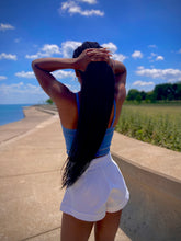 Load image into Gallery viewer, We're bringing the heat with these flowy swing it baby shorts! Great for day parties with your girls or even a night out with your bae! These shorts come in a soft white material, front zip and button closure. Style these sexy shorts with a rhinestone denim corset, simple high heels and handbag for a complete look!