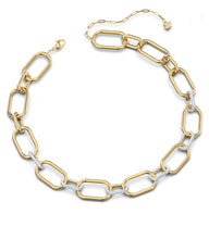 Load image into Gallery viewer, A celebration of femininity and modern design, this Swarovski necklace draws inspiration from the hardware trend. Two elongated chain links holding onto each other – one shimmering softly, one covered in clear crystal pavé – take center stage.
