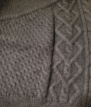 Load image into Gallery viewer, Get in touch with your wardrobe this season with this cute knitted sweater. Featuring a black hue twisted cable knit material with a cropped fit, asymmetrical shoulder cut-out adds a flirty touch. It's super soft with the right amount of stretch we're in love. Pair this with your favorite high rise denim jeans, high heels or boots and gold hoop earrings for an effortless vibe.