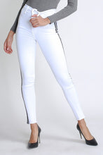 Load image into Gallery viewer, Flex your style in these cute white skinny Jeans with a contrast black stripe designs. Perfect for styling any and every way you want! These jeans come in a high rise fit featuring a raw uneven hem ends, zip and button closure. Pair with a graphic tee or chic fashion top, high heels or combat boots and of course a handbag for a complete look!