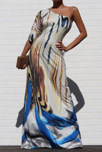 Load image into Gallery viewer, Keep your look like a work of art, in this dreamy maxi dress. Featuring a white, blue and brown material with a one shoulder neckline, we're in love. Add gold earrings, white high heels, and a matching purse to keep the look effortlessly amazing.
