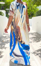 Load image into Gallery viewer, Keep your look like a work of art, in this dreamy maxi dress. Featuring a white, blue and brown material with a one shoulder neckline, we're in love. Add gold earrings, white high heels, and a matching purse to keep the look effortlessly amazing.