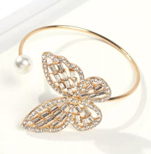 Load image into Gallery viewer, A statement bracelet is a must have in your wardrobe this season or a perfect gift for any occasion. Adjustable and a comfortable fit that works for you. Featuring a classic butterfly design and the silver pearl placed on the end of the open bangle creates a new artistic beauty on you. The rhinestones have a remarkable glisten to it, and when light hits them the effect is truly special.