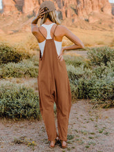 Load image into Gallery viewer, This Sunrise jumpsuit features a striking V- neckline, pockets and lots of stretch for added comfort, this full-size sleeveless jumpsuit comes in a variety of colors. Our Sunrise jumpsuit is stylish, comfortable and its lightweight fabric makes it ideal for summer or fall events, such as brunch or a family BBQ. Style with a bag and your favorite sandals for a complete look.
