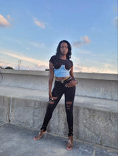 Load image into Gallery viewer, Too hot to handle, this sexy but stylish Denim Corset Knit Top is a soft and stretchy cropped t-shirt complete with a crew neckline, a back zip, short sleeves, and a denim corset overlay. With this top, you can dress up or down any outfit. Style this cute tee with a miniskirt, a pair of thigh high boots and don’t forget a patchwork denim purse.