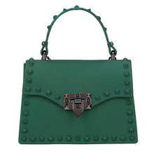Load image into Gallery viewer, Are you ready to make a statement, babe? This rubberized trendy bag features a soft matte sage finish, studded detailing, gunmetal hardware with a locking clasp, a roomy interior compartment and also includes a crossbody strap. It's time to bring some edge and ambition to your look, sis!