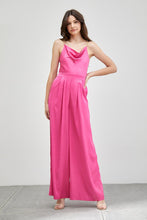 Load image into Gallery viewer, Our Above Status Satin Jumpsuit perfect blend of sophistication and texture that adds a touch of elegance to your wardrobe. This satin jumpsuit features a cowl neck design with intricate trim detailing, meticulously woven to create a unique and visually captivating ensemble.
