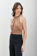 Load image into Gallery viewer, The Good Life Smocked Waist Satin Crop Top is a wardrobe staple you&#39;ll turn to again and again. Constructed from soft breathable satin feel material, this unique toffee color blouse can be styled with black slacks or jeans for any event, from happy hour to lunch. Finish off the look with a stylish bag and cute gold earrings.

